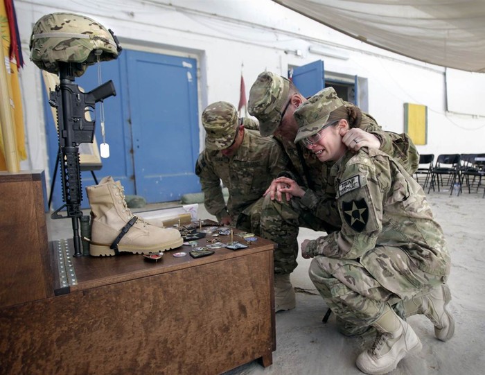 Hạ sĩ Katie Luna thuộc Trung đoàn Kỵ binh số 1 khóc khi tưởng niệm người đồng đội Brittany Gordon ở trại Nathan Smith, tỉnh Kandahar miền nam Afghanistan hôm 19/10. Hạ sĩ Gordon cùng với một nhân viên dân sự Mỹ và 2 người khác đã thiệt mạng sau khi một cảnh sát Afghanistan nổ bom tự sát.